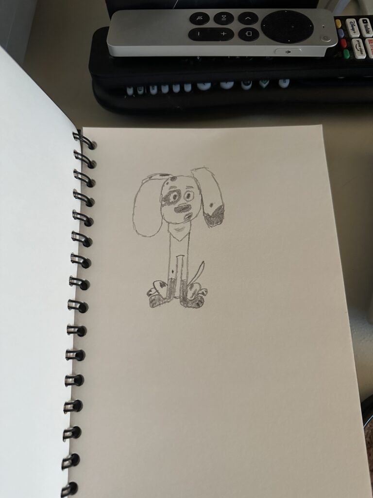 My sketch pad with a rough charcoal sketch of Da Vinci.